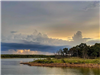 Shoreline at Skiatook Lake with clouds in the distance.