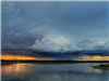 Wide view of clouds over the lake at sunset.