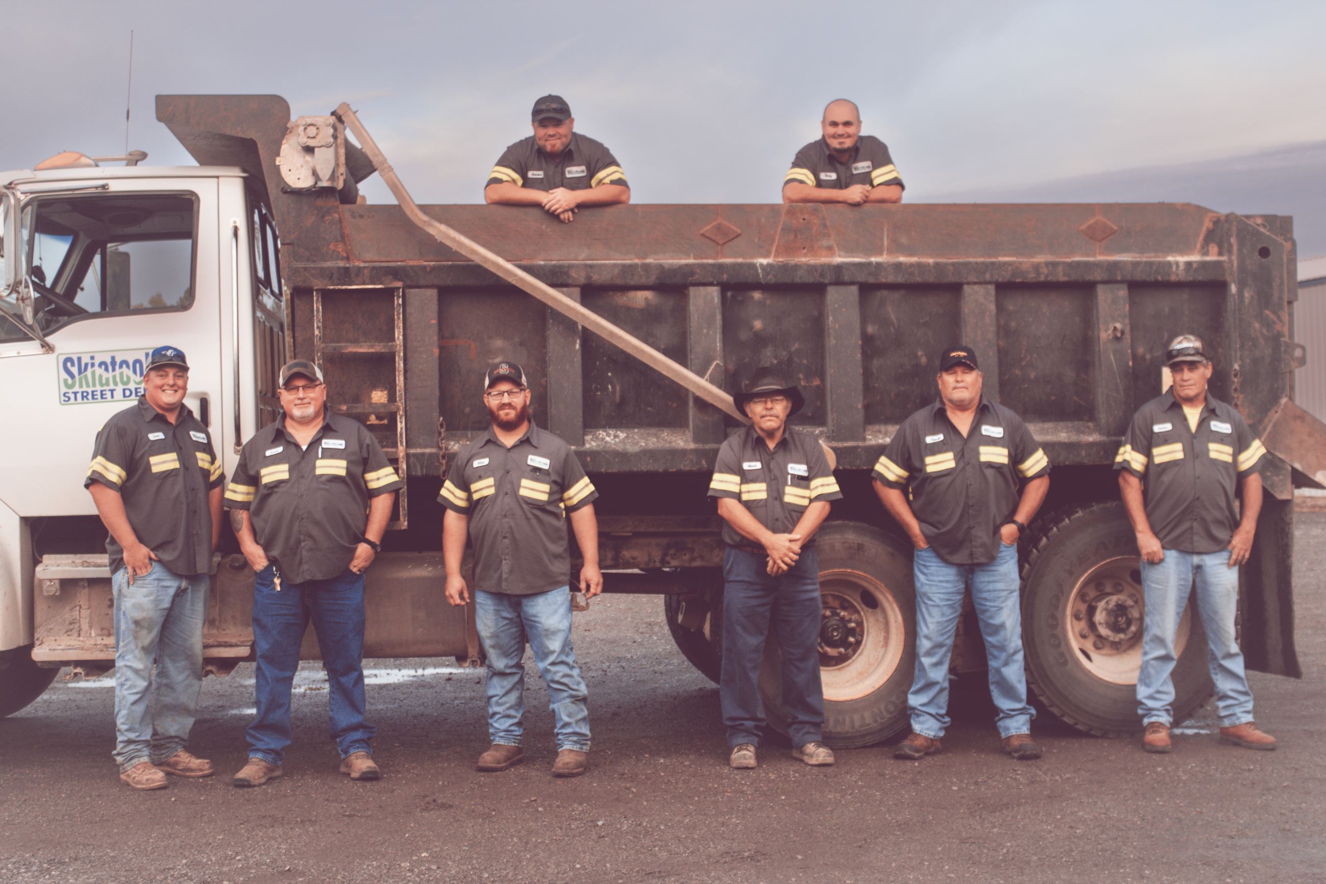 Street Department personnel around a dump truck